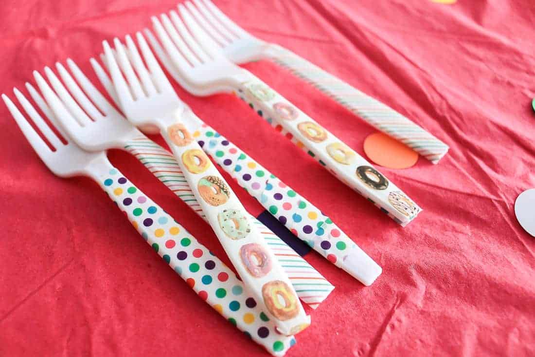 Plastic forks decorated with donut and polka-dot washi tape for a donut-themed baby shower.