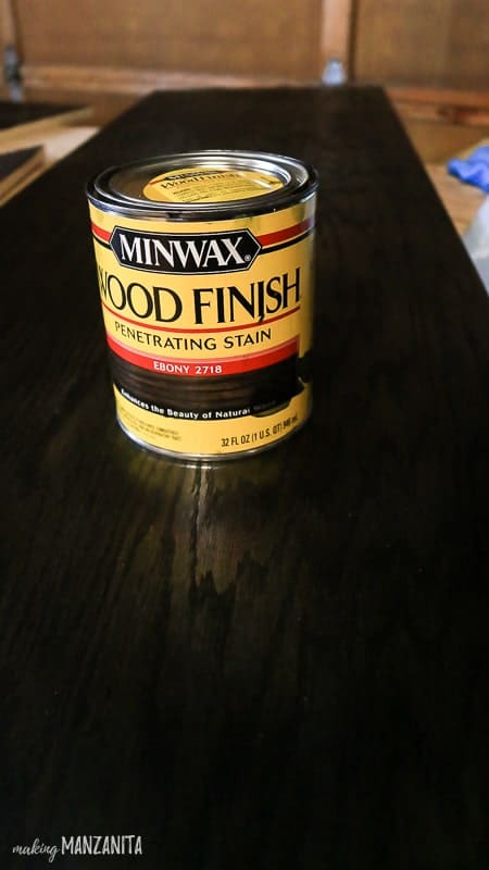 Can of Minwax Wood Finish sitting on top of plywood panel