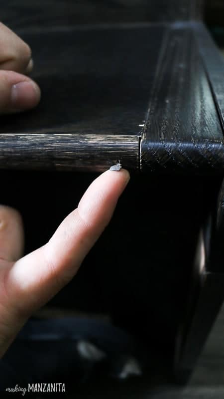 Man putting in wood putty in nail holes 