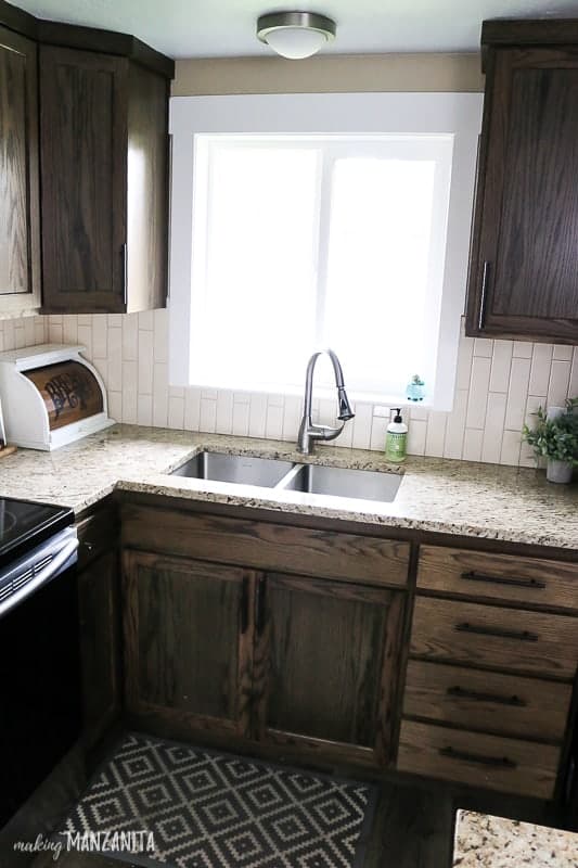 Photo of the farmhouse kitchen sink with subway tile before the undermount sink installation 