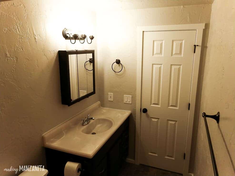 A complete view of our small guest bathroom with an updated look - textured painted walls, painted mirror, and painted vanity.