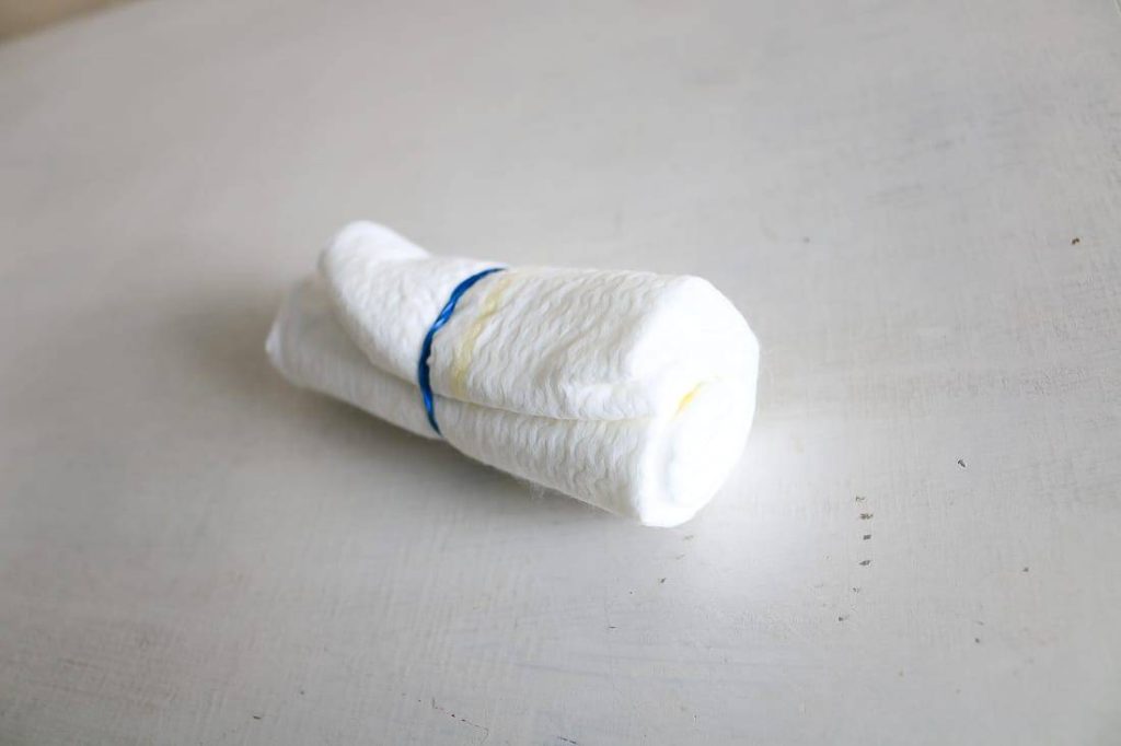 Rolled diaper tied with a rubber band