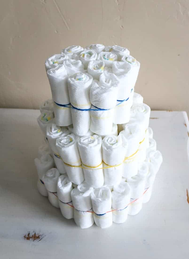 Cake looking structure made from rolled up diapers tied together with rubber bands