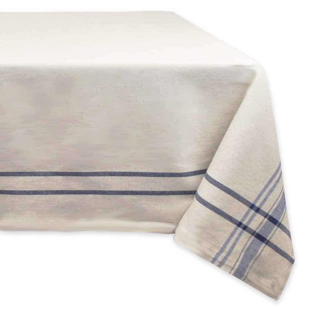 A white tablecloth with a simple blue pinstripe bordern