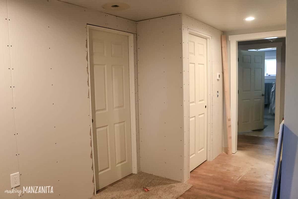 Two door ways with drywall up on the walls nearby showing an in progress renovation