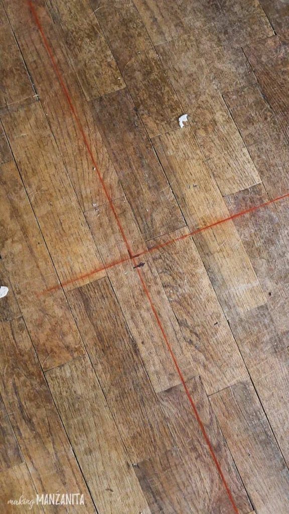 Red chalk lines on floor indicating where new wall will be built