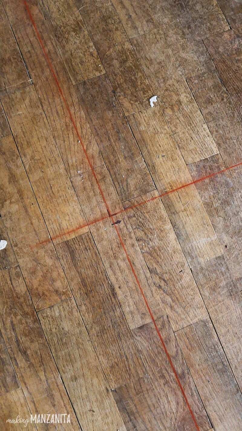 Red chalk lines on floor indicating where new wall will be built