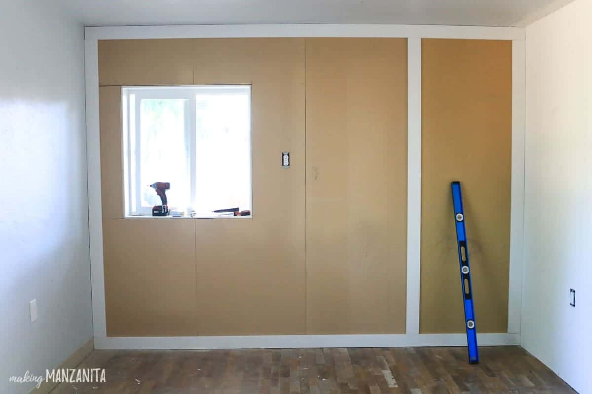 View of progress on a DIY board and batten wall. Some of the vertical batten pieces are installed. 