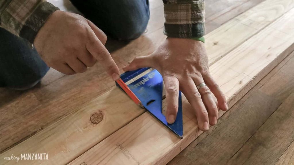 Marking your top and base plates for vertical studs with a pencil and square