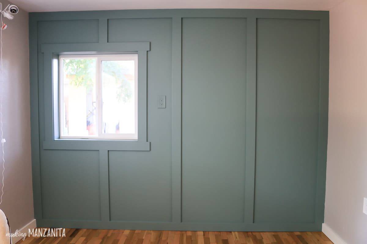 Floor to ceiling board and batten wall treatment with window painted blue green In the Moment by Behr