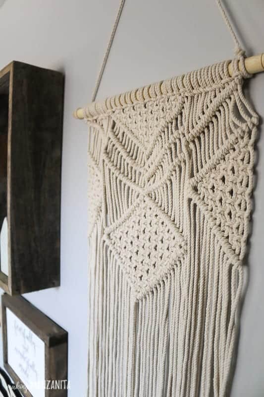 Macrame wall hanging adds texture to a boho style gallery wall