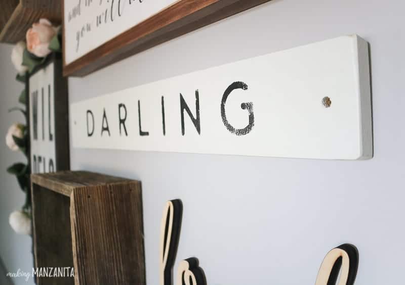 Rustic darling sign in a baby girl's nursery gallery wall