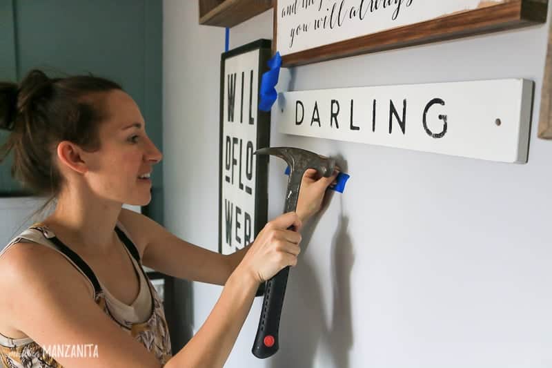 Using painters tape to mark placement for gallery wall decorations