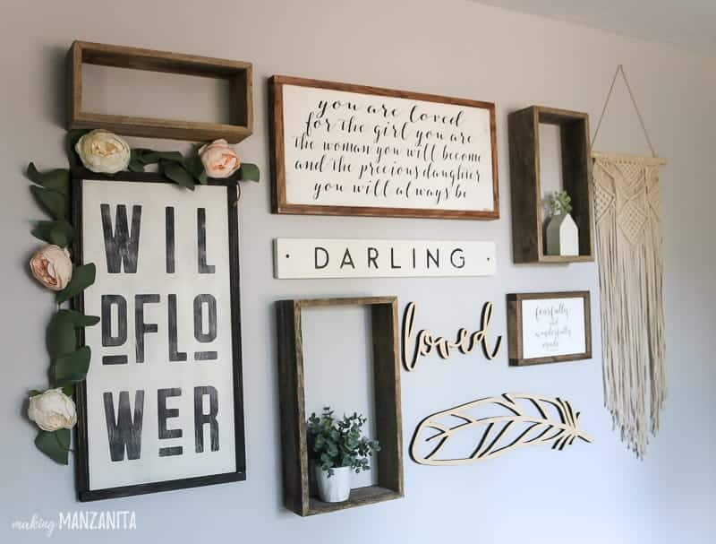 Rustic boho gallery wall layout for baby girl nursery