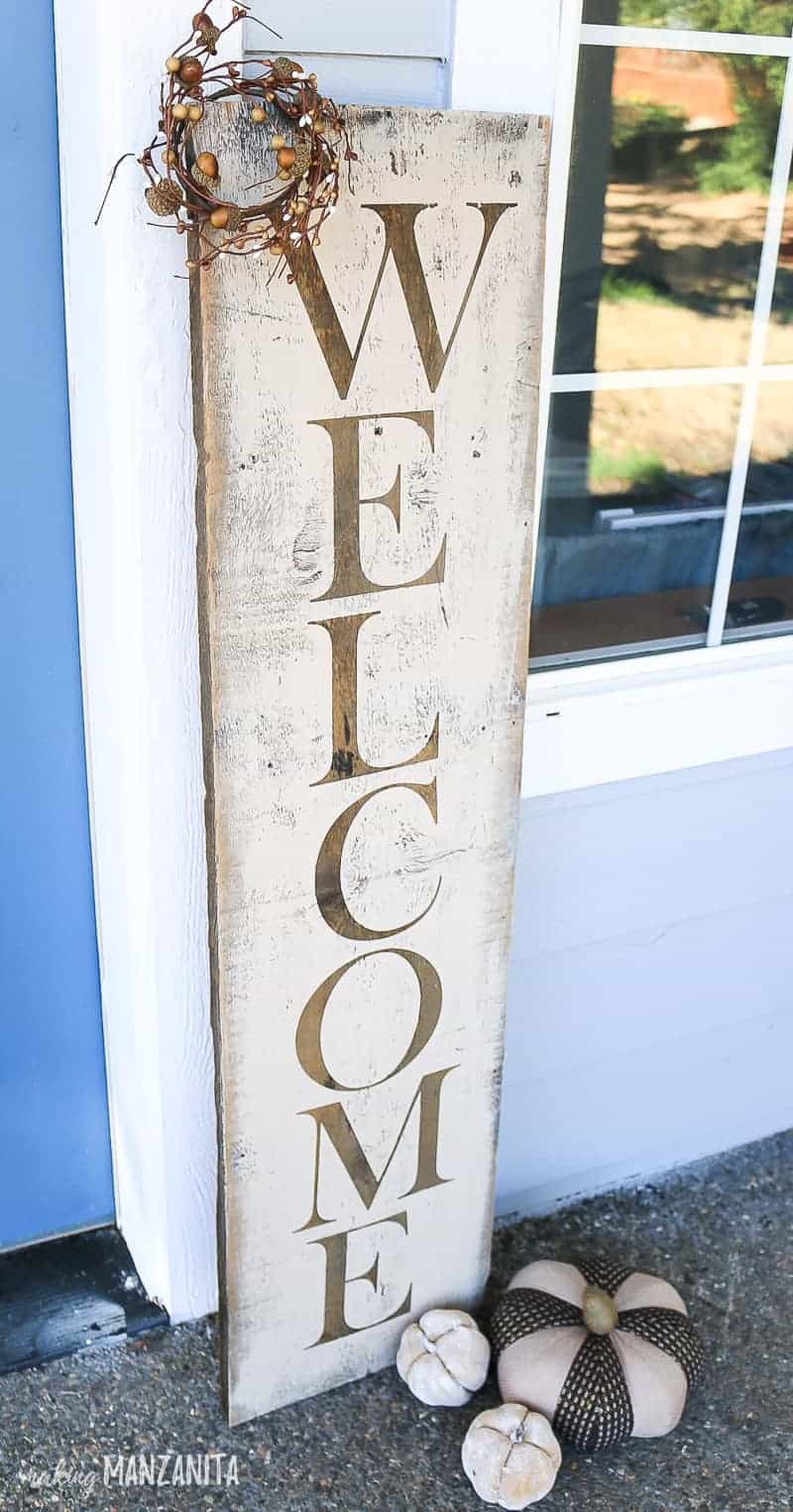 Rustic fall welcome sign make with stencils and styled on front porch