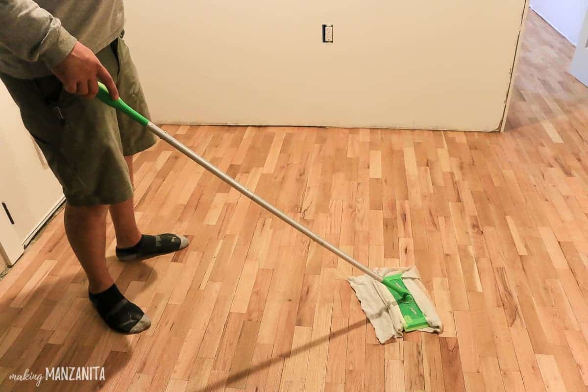 To clean up the dust in between coats of finish, use a Swifter cleaning mop with a cleaning cloth.
