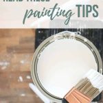 Gallon of paint with brush laying on top with text overlay that says before you start painting read these painting tips