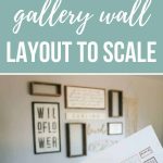 Hand holding printed gallery wall design on paper in front of the real gallery wall with text overlay that says how to design a gallery wall layout to scale