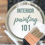 Paint bucket sitting on stool with paint brush with text overlay that says interior painting 101