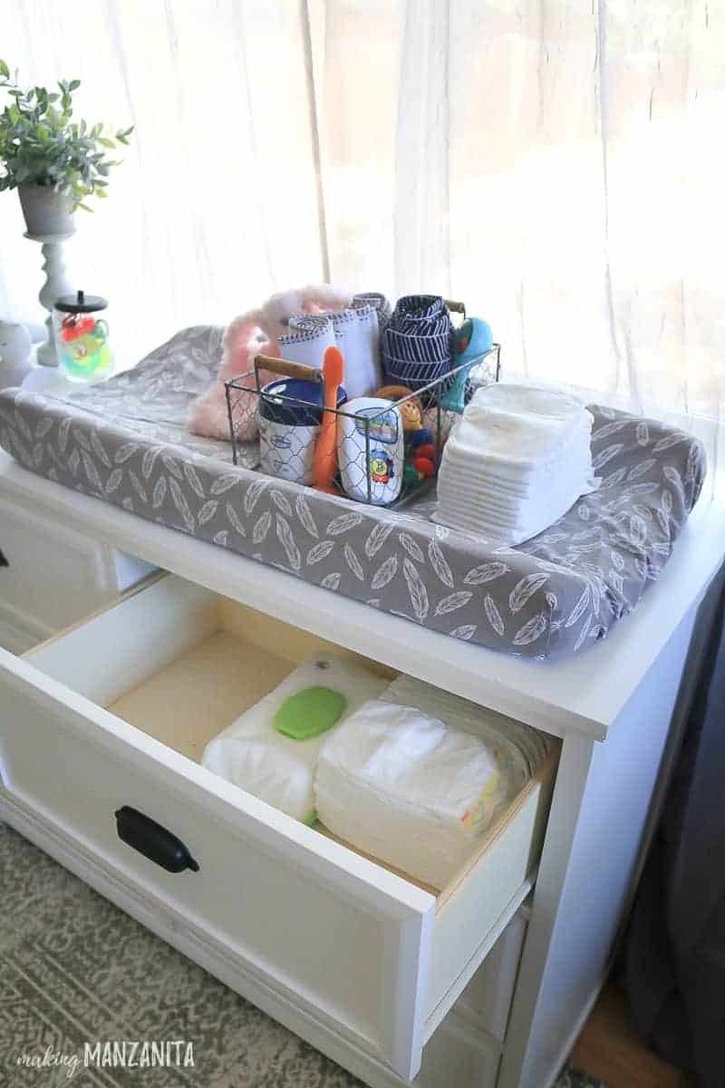 A changing table dresser with drawers is easy to organize with wire baskets to hold diapers, liners, toys and more