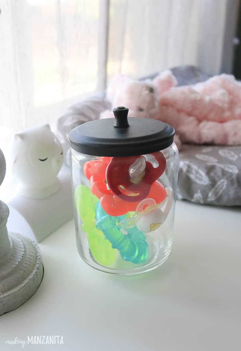 Glass jars to hold pacifiers and teethers are great for organizing your baby's changing table