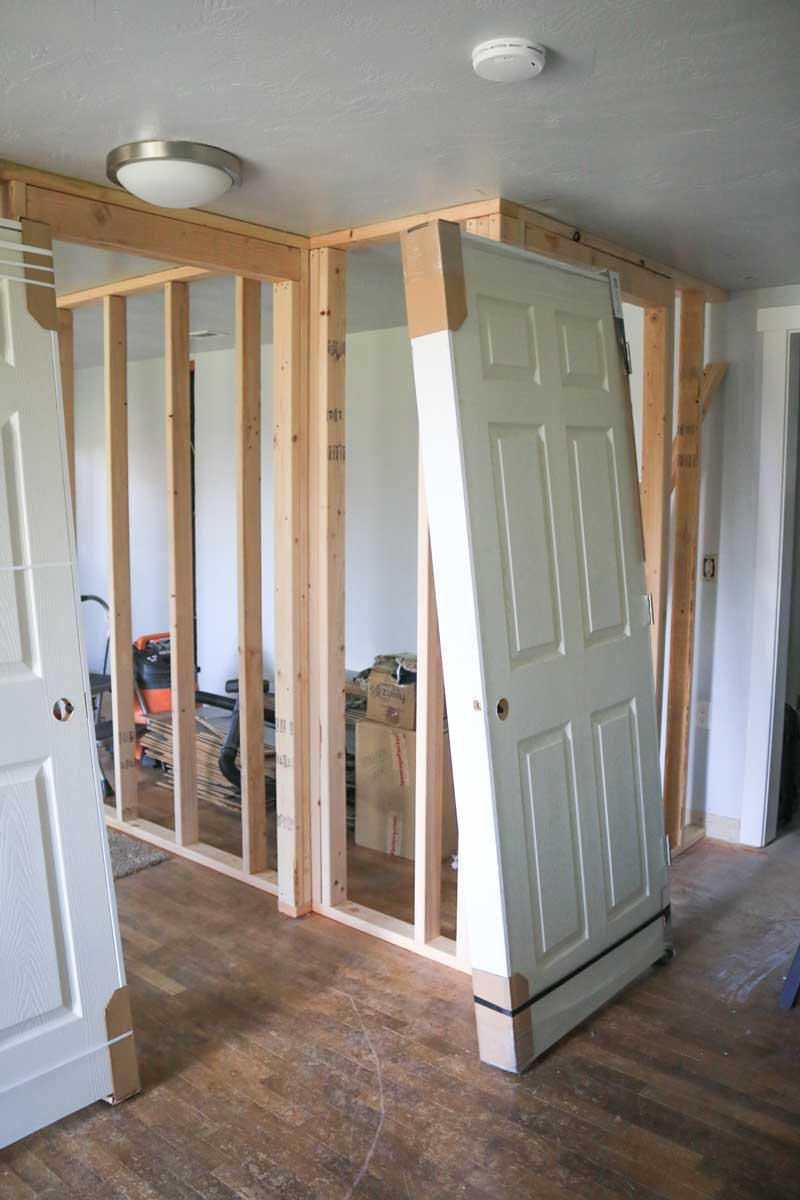 Stud walls up with prehung doors leaning against them