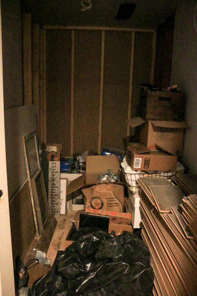Small room with tons of junk in it that will ultimately be renovated into a bathroom