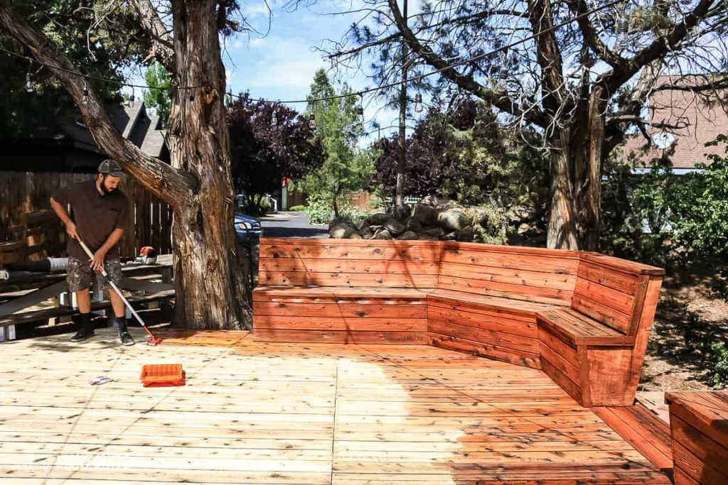 shows the patio being stained with penofin oil