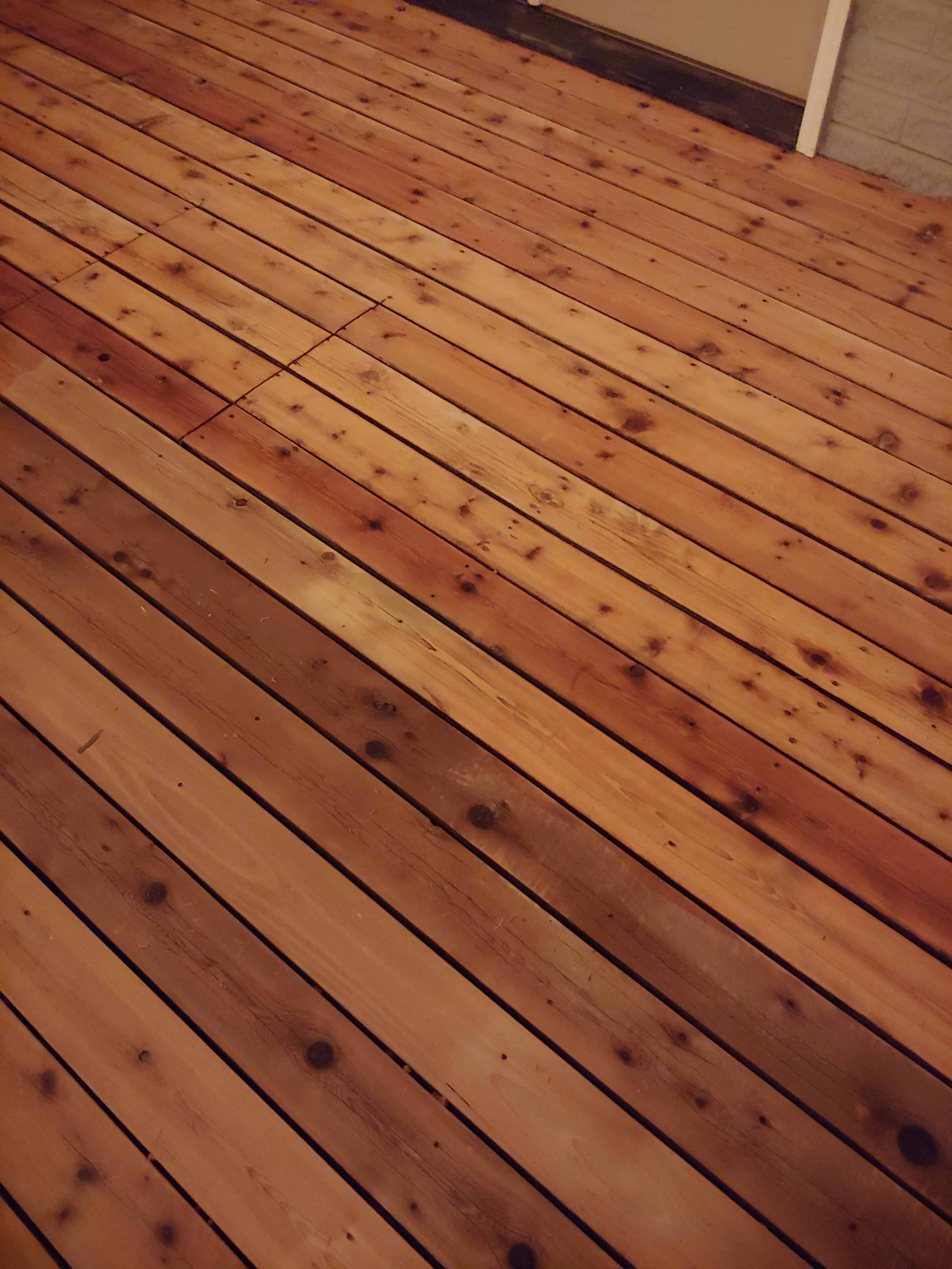Montre la différence spectaculaire de l'application d'un azurant pour bois lors de la remise à neuf d'une terrasse en bois