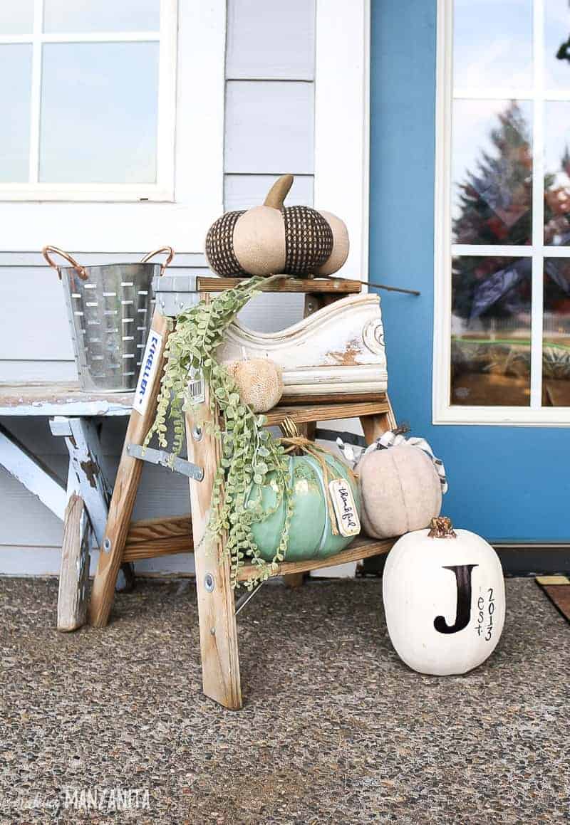 Small wooden step stool with white pumpkin decor for front porch for fall