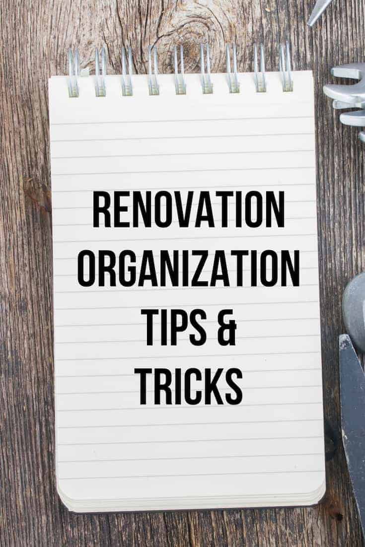 Renovation organization tips and tricks written on a notepad sitting on a wooden background
