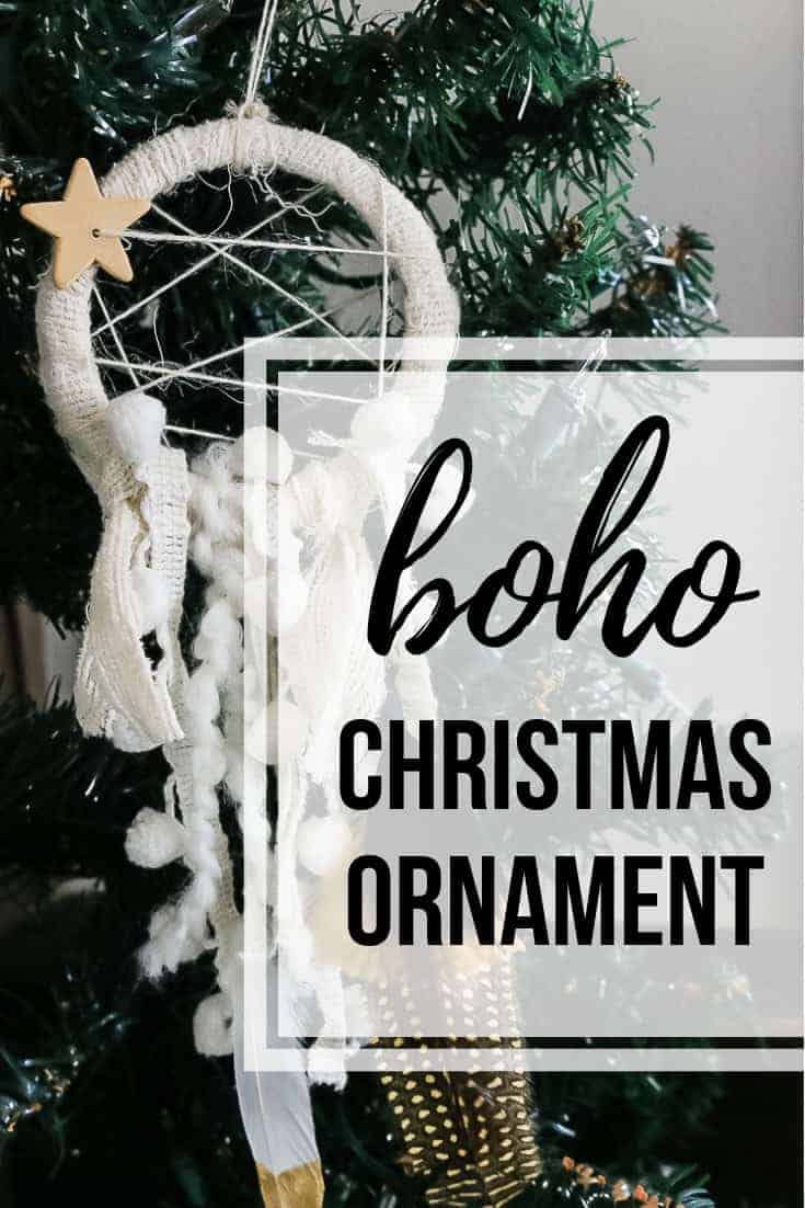 White fabric dreamcatcher ornament hanging on Christmas tree with text overlay that says boho Christmas ornament.