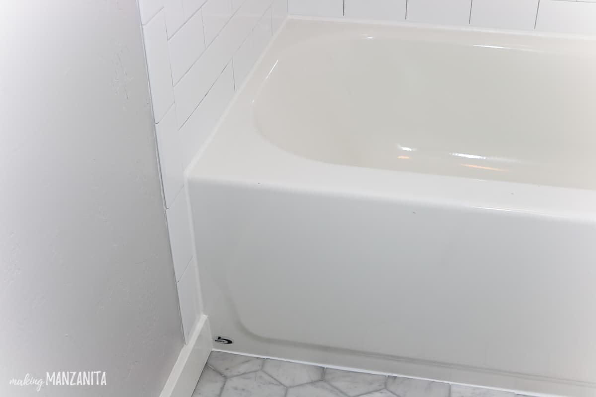 Corner view of shower bath tub showing shower caulk lines