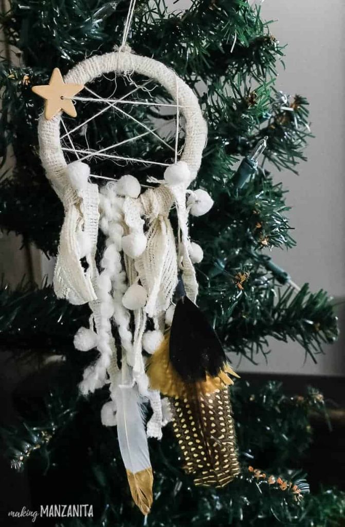 A detailed close-up of a Christmas tree adorned with a whimsical dream catcher ornament, adding a playful and enchanting touch to the festive holiday display.