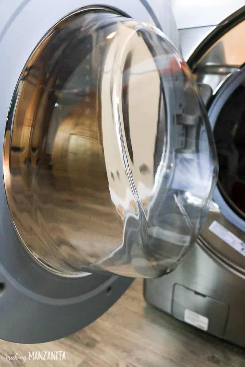 The interior window of the washing machine door is cleaned and wiped down after running the cleaning cycle.