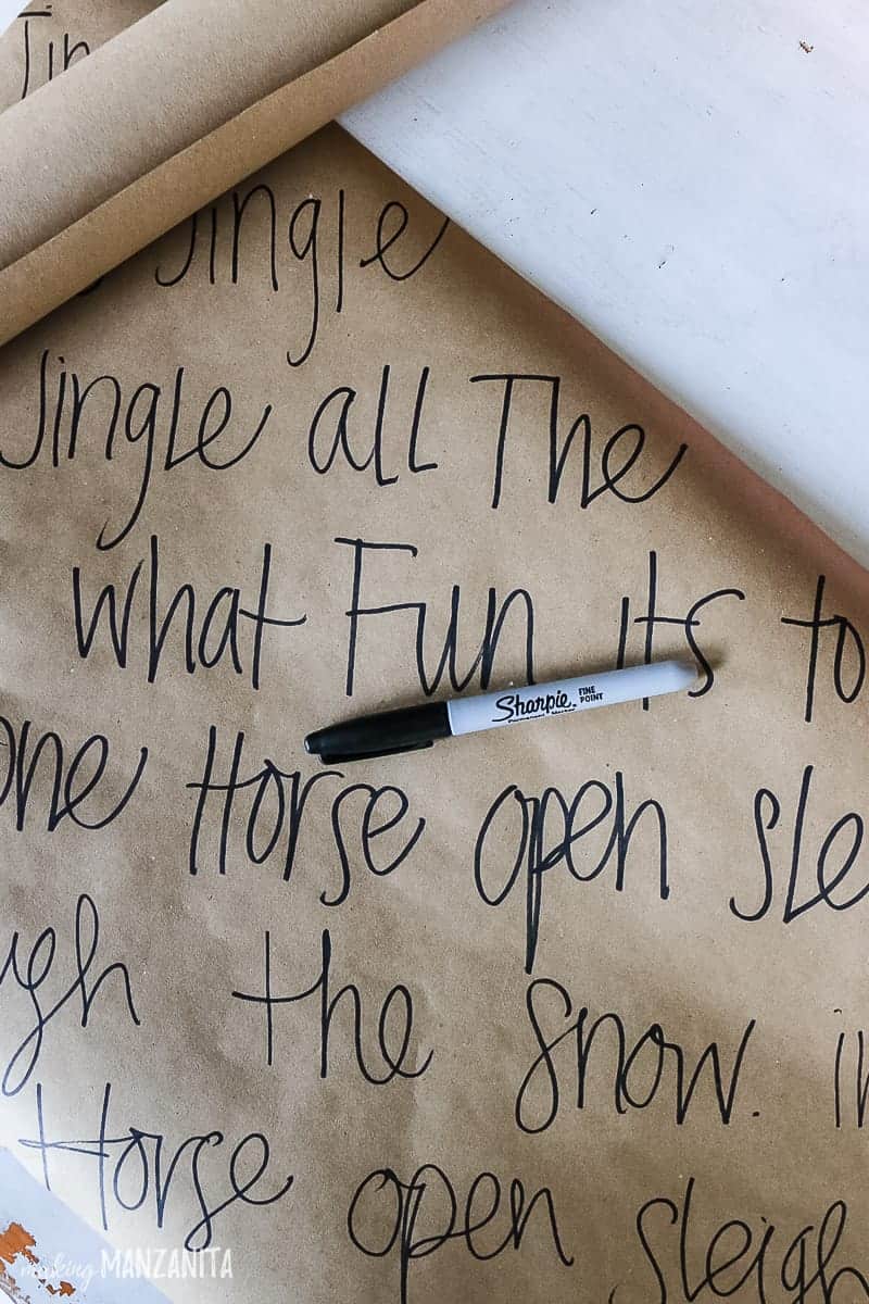 Sheets of brown paper with festive song lyrics used to wrap Christmas and holiday gifts.