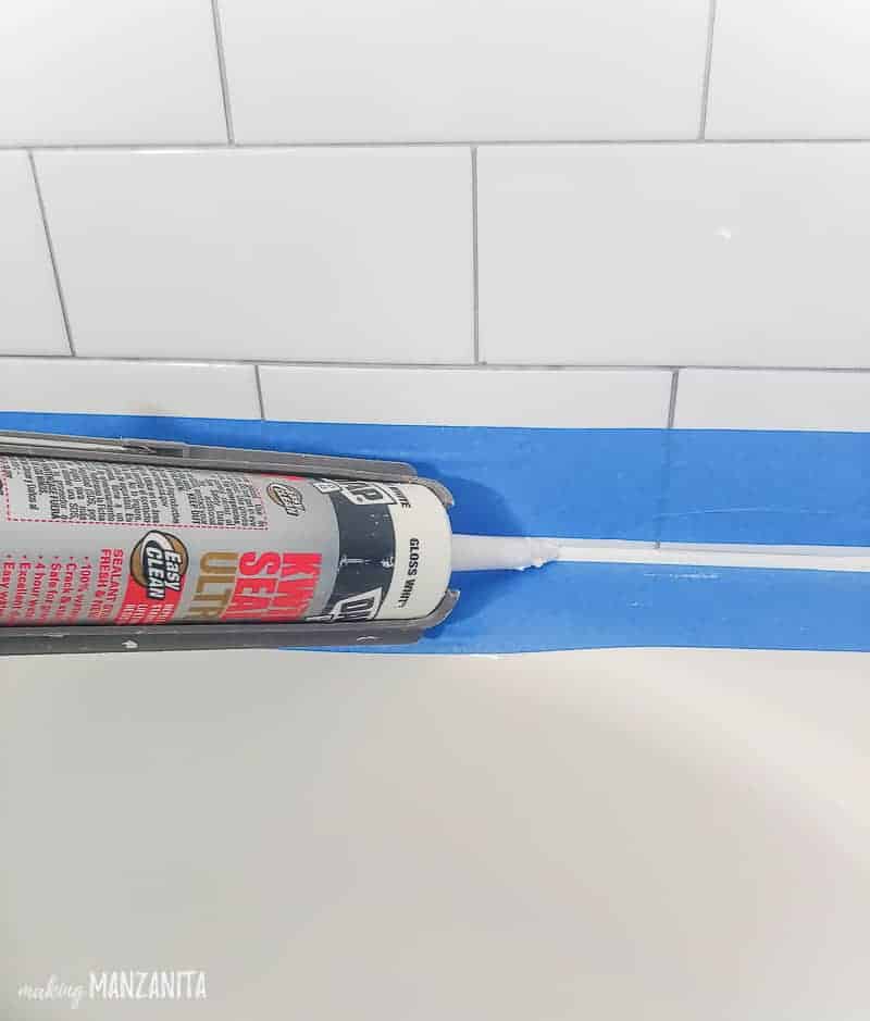 Dap Kwik Seal Ultra getting added in a shower where the bath tub meets the shower wall tile