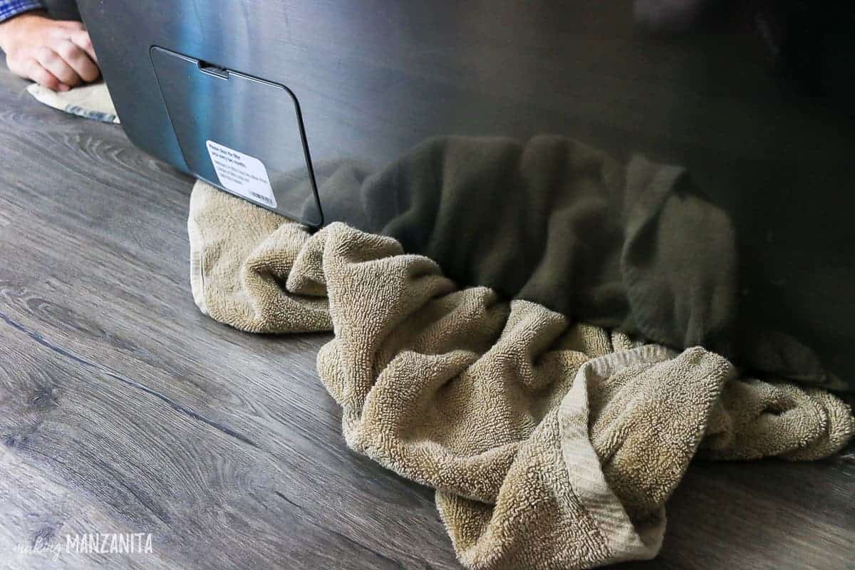 When cleaning your washing machine - especially before cleaning the filter - tuck a towel under the washing machine to catch any excess water that might spill out.