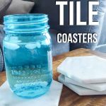 Glass of water in mason jar sitting on hexagon tile coaster on table with text overlay that says easy tile coasters