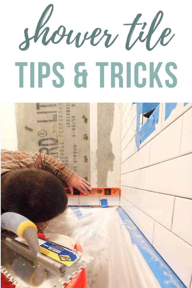 Man installing shower wall tile and leveling the bottom row with text overlay that says shower tile tips & tricks
