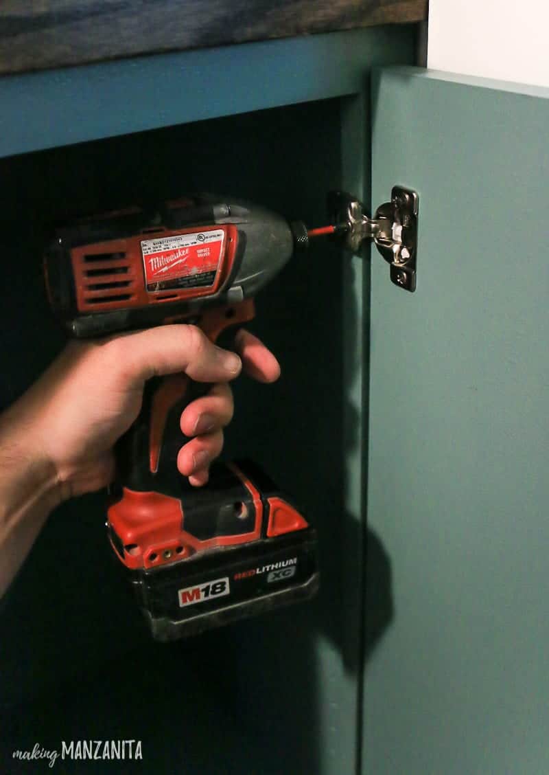 Installing soft close door hingers on the hallway cabinet doors.