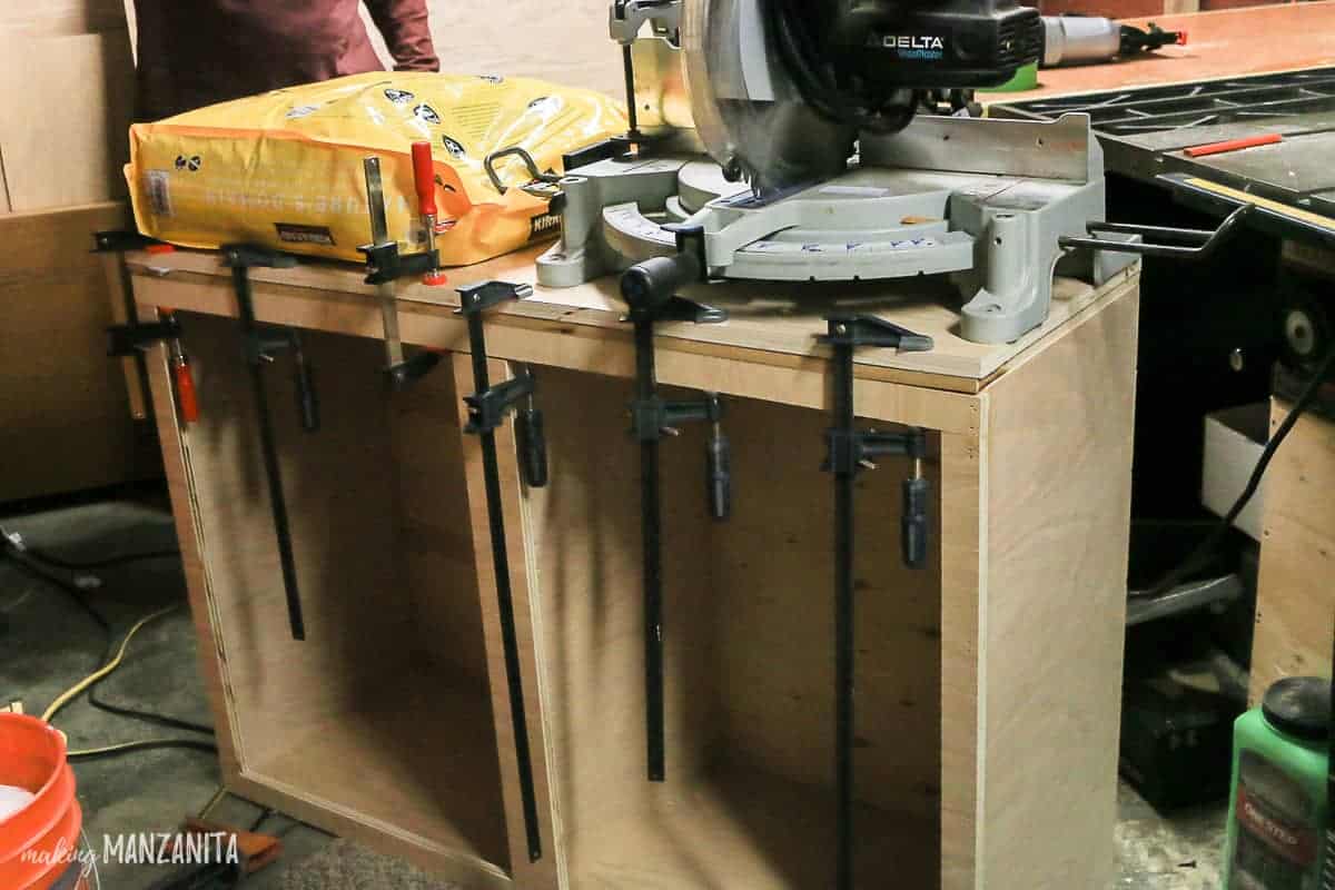 The countertop sits atop the hallway cabinet, weighed down with heavy equipment to perfectly adhere the countertop to the cabinet.