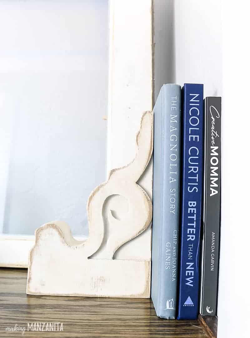 A close up look at a vintage corbel used as a bookend on the surface of our new hallway cabinet.