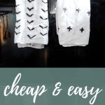 Two custom tea towels painted with arrows and crosses hanging on oven door with text overlay that says cheap & easy DIY tea towels