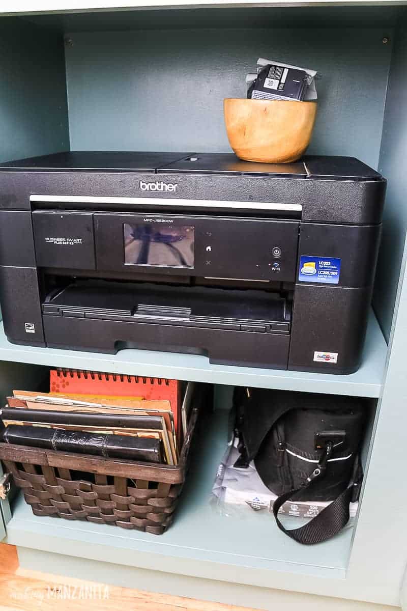 Storing our printer, notebooks, camera bag, and other various equipment in our new hallway storage cabinet.