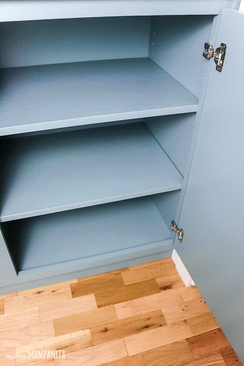A look inside our new hallway cabinet we built for extra storage, which includes adjustable shelving and soft-close hinges.