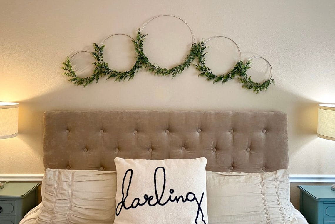 If you're looking for wreath above ideas, why not try these asymmetrical  hoop wreaths with greenery added. 