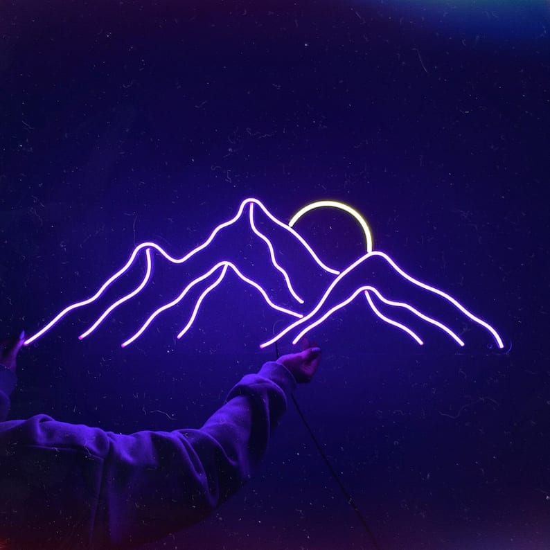 Stumped on what to do in your master bedroom for over the bed decor? Why not a trendy retro neon sign, like this mountain scape with sunrise? 