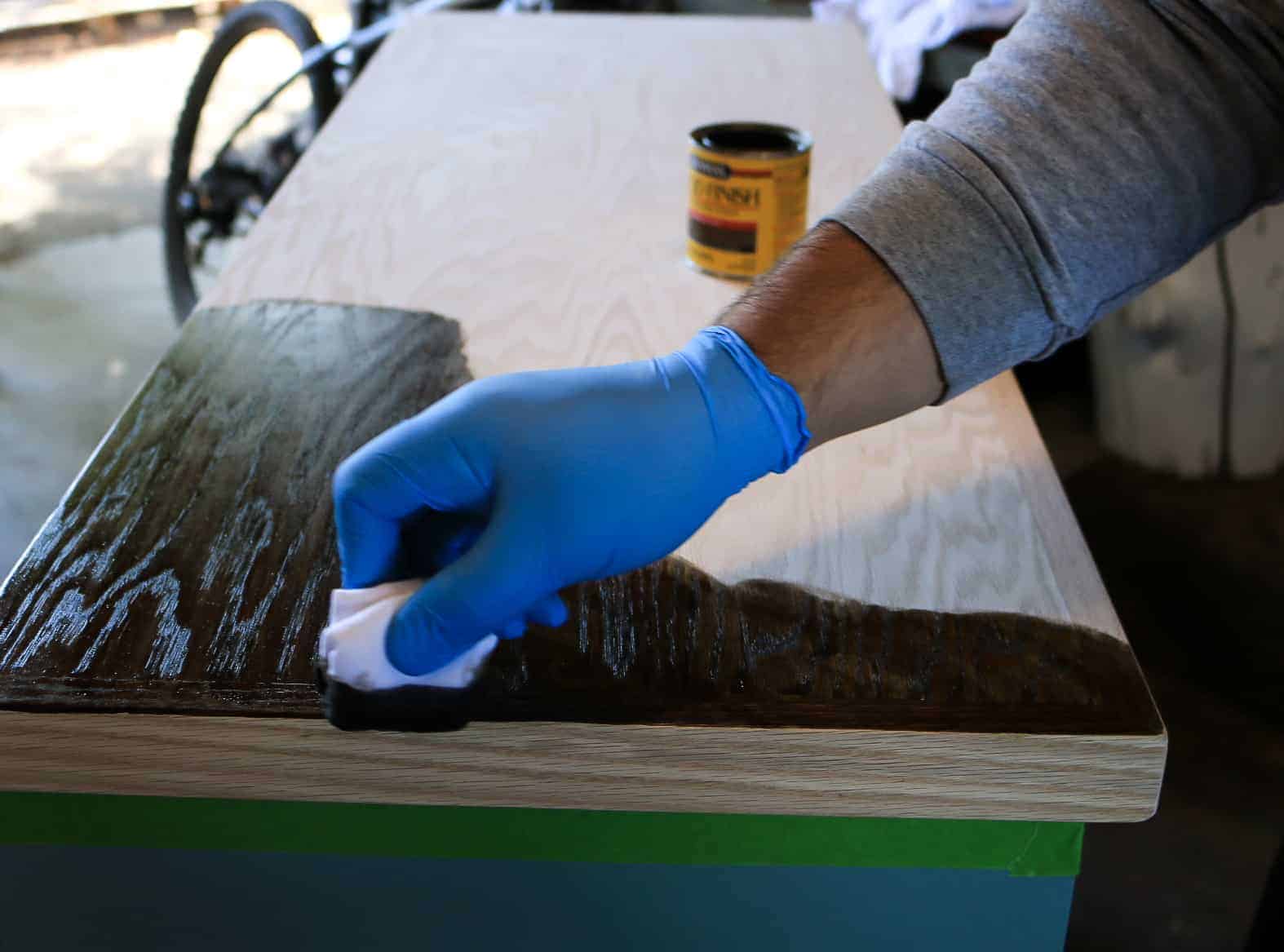 Using a dark wood stain to stain the wood countertop of the hallway cabinet.