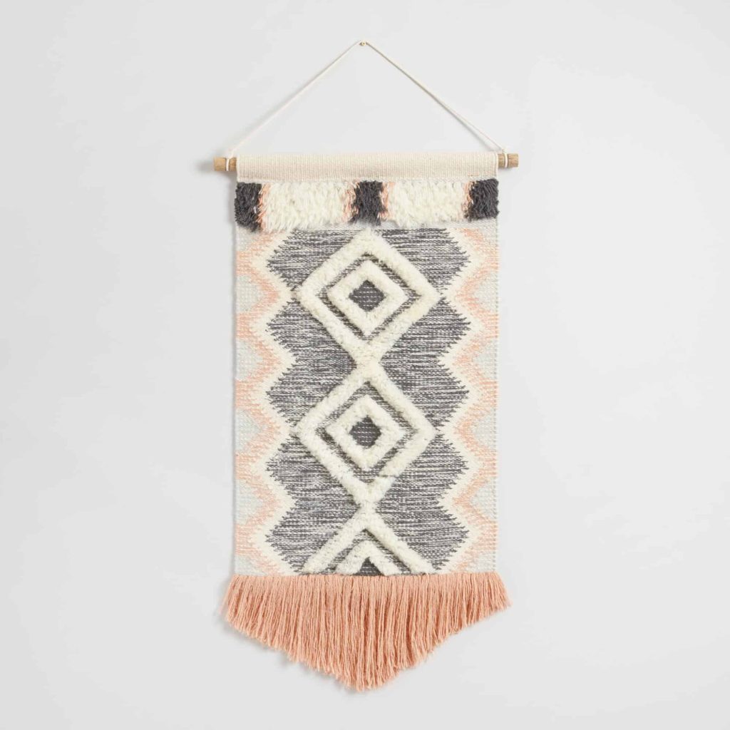 I'm really loving the idea of hanging a boho style wall hanging above your bed! How cute is this coral and gray fringed wall hanging from World Market? 